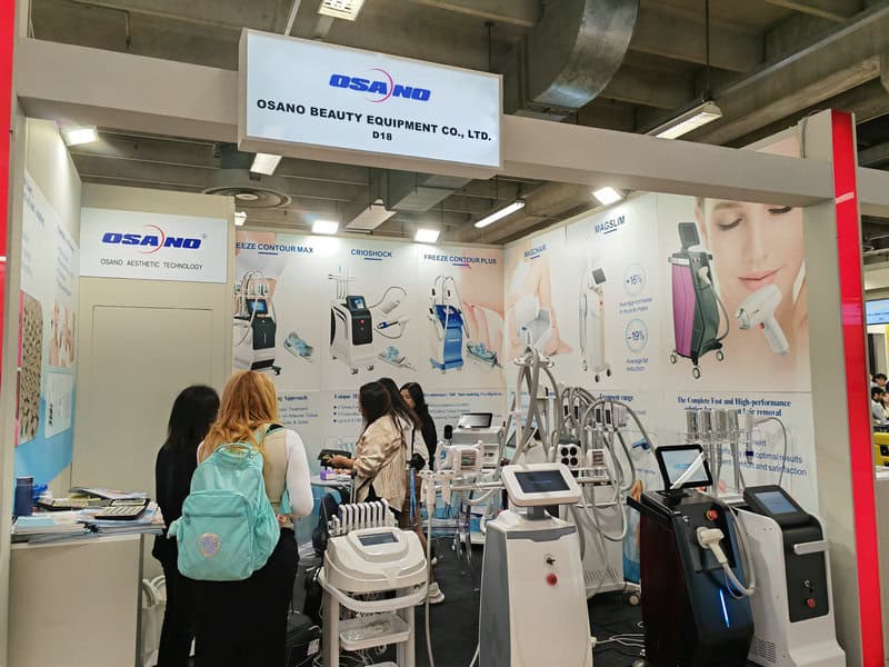 Booth at Cosmoprof Worldwide Bologna 2024 showcasing beauty and medical equipment, with attendees viewing devices and posters.