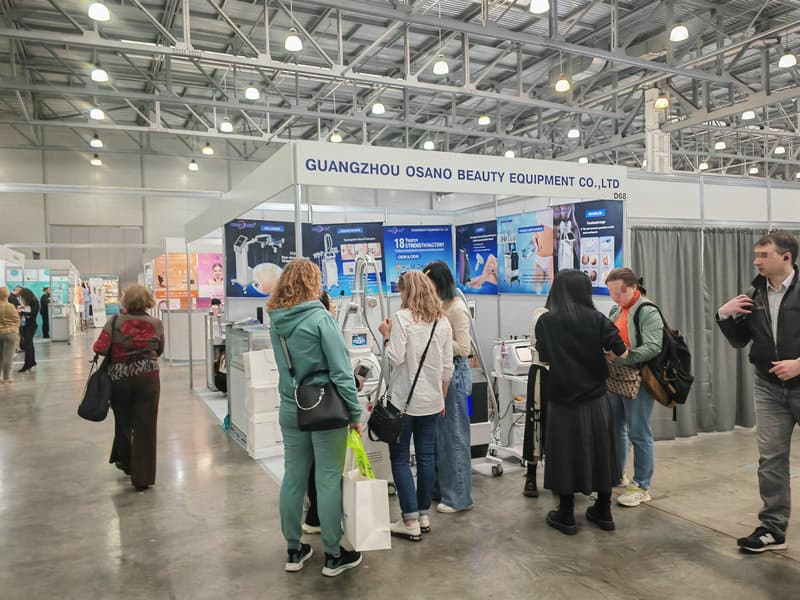 People browsing equipment at the Guangzhou Osano Beauty Equipment booth at InterCHARM, Russia's top beauty show.