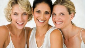 Vibrant women smiling together, showcasing comfort and happiness, representing wellness and self-care with a focus on comfort products for a healthy lifestyle.